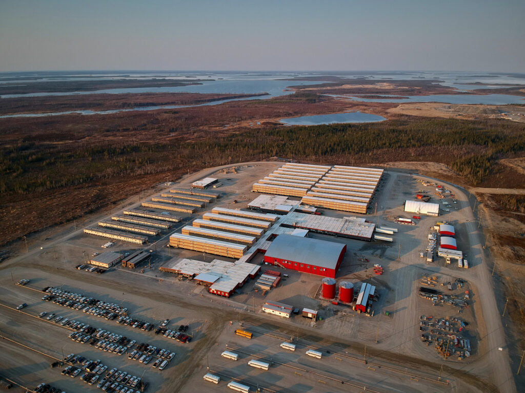 A drone view from overhead showing the camp buildings; including the dorms, the gym, the dining hall/kitchen, and the other facilities - all in one huge, connected structure.