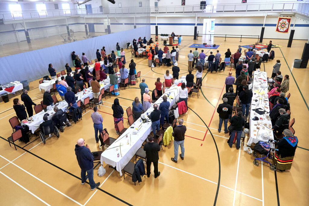 The gymnasium at Keeyask is set up with places for the ceremonies and speakers, and with tables for everyone.